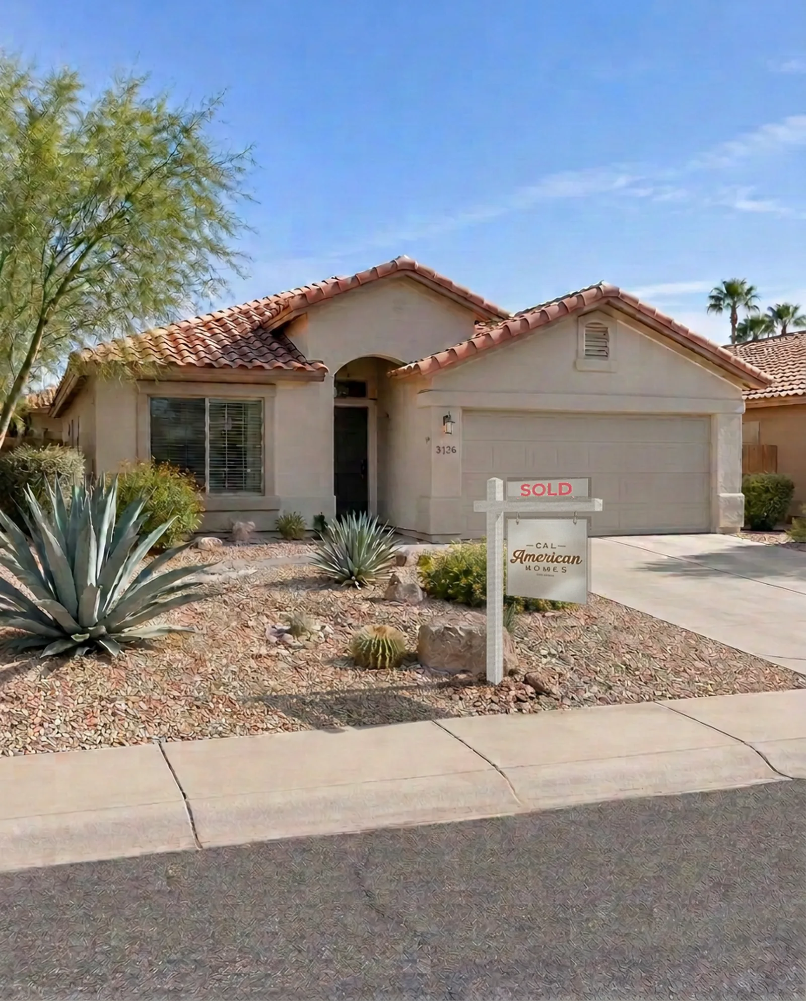 Renovated single-story stucco home with a clay tile roof, desert landscaping and a Cal American Homes sold sign